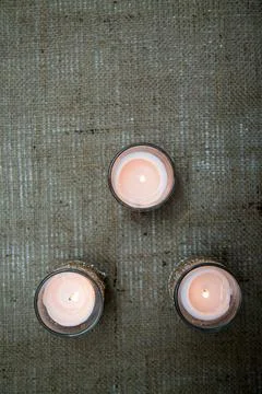 Vertical top view of three candles in a triangular shape Stock Photos