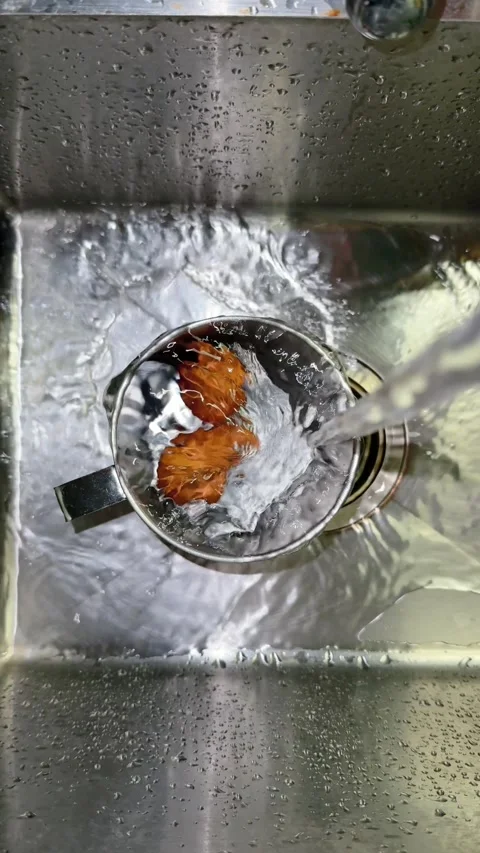 Vertical top view of Two Boiled Eggs Cooling in Steel Mug Under Cold Water Video stock 341457124