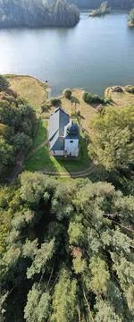 Vertical top view of the Zahradka church in front of a river surrounded by trees Stock Photos