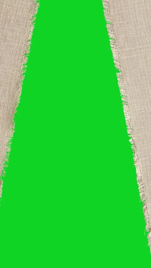 Vertical torn canvas fabric texture split space revealing animated on green Stock Footage 335216678