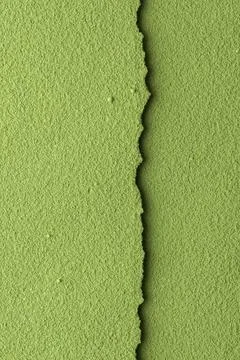 Vertical torn matcha paper texture with rough edge creates vivid organic Stock Photos