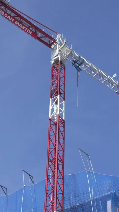 Vertical Tower Crane Against Blue Sky at Residential Construction Site Stock Footage 336012082