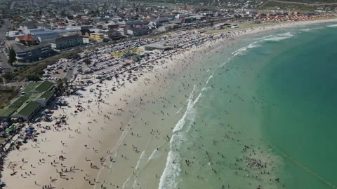 Vertical track along a Busy Fish Hoek Beach. Video stock 296369868
