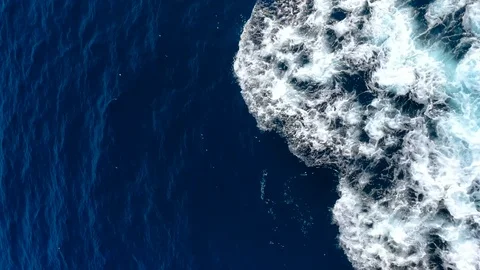 Vertical tracking shot of drone flying over water edge ocean shore  Stock Footage 106434631