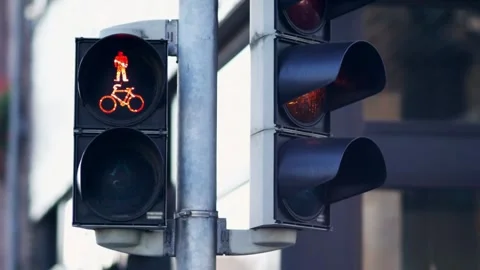 Vertical traffic light against a backdrop of blue sky and skyscrapers, Stock Footage 256737341