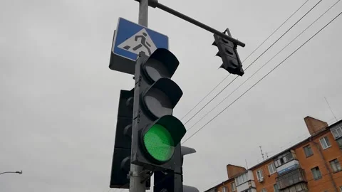 Vertical traffic light with blue sky and high-rise buildings in the background.  Video stock 270519241