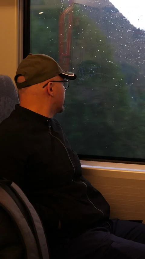 Vertical. Train passenger looking through window focus on man. Vídeos de archivo 283841756