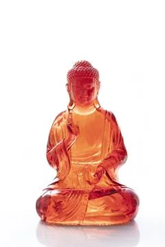 Vertical of a Translucent Red Buddha Figurine on White Background Stock Photos