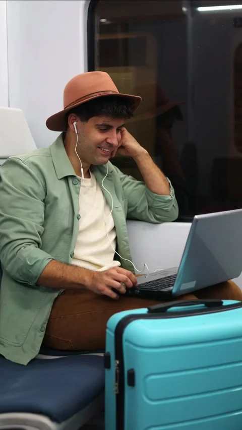 Vertical traveler relaxing on train watching movie with laptop and headphon.. Stock Footage 298562995