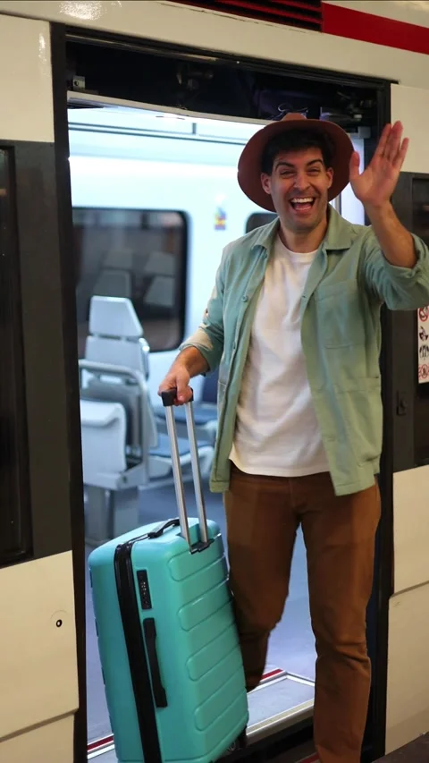 Vertical traveler waving at camera while getting off train, happy to reunit.. Stock Footage 298563032