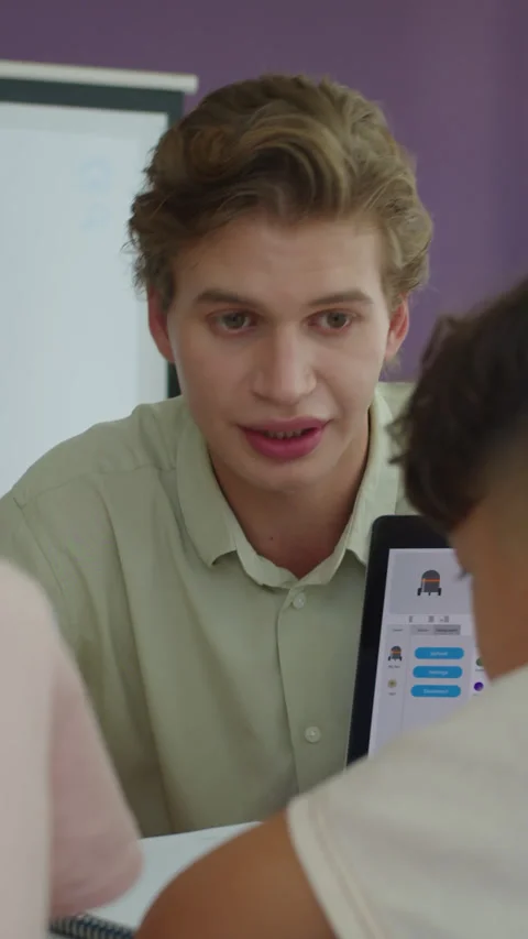 Vertical of Tutor Helping Kids with Task at Programming Class Stock Footage 280638081