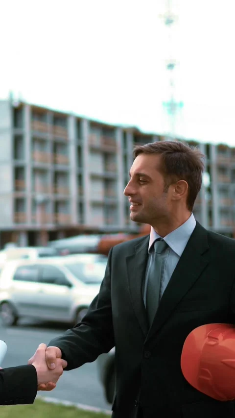 Vertical of Two architect discuss new building and make handshake. Stock Footage 305473062