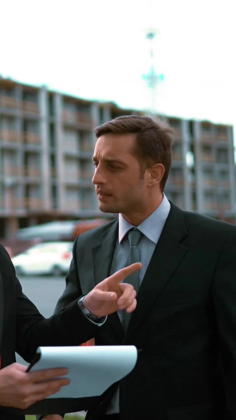 Vertical of Two architect discuss new building and shows thumbs up Stock Footage 305474317