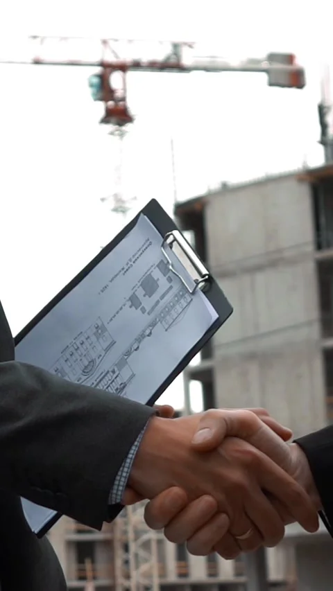 Vertical of Two builders are shaking hands Stock Footage 305496869