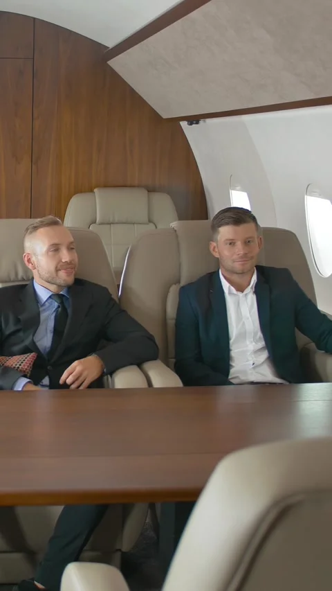 Vertical of Two businessmen talking inside of private jet. Stock Footage 277277958