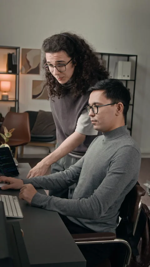 Vertical of Two Gen Z Programmers Checking for Site Errors Working in IT Office Stock Footage 329611756