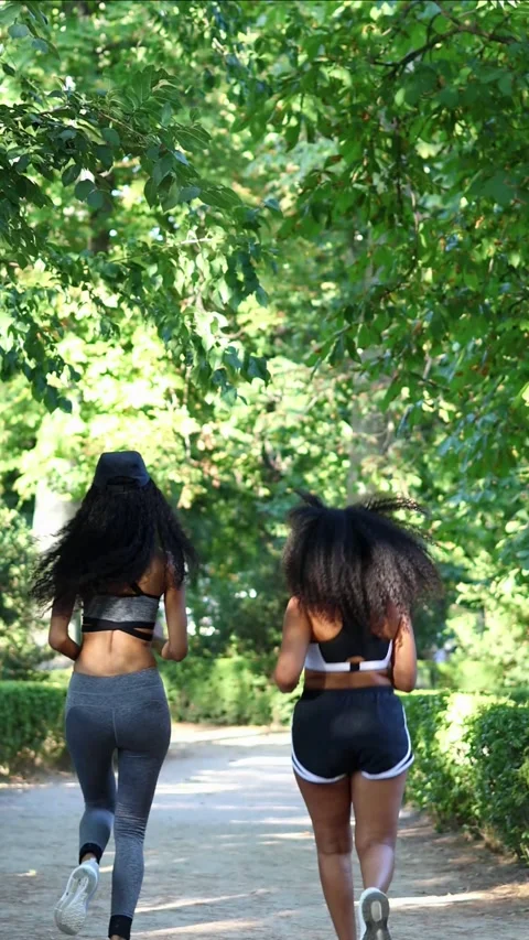 Vertical Two Latin athletes running inside a park Stock Footage 316259182