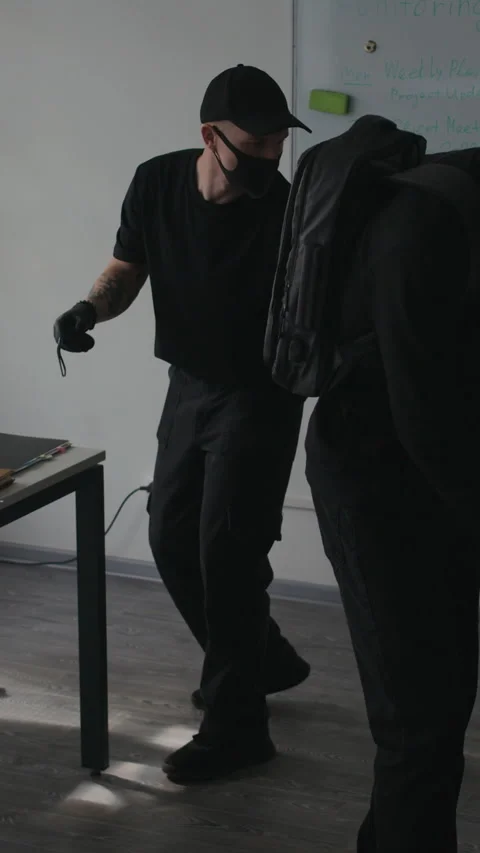 Vertical of Two Male Thieves Stealing Folder with Secret Data from Office Stock Footage 313555586
