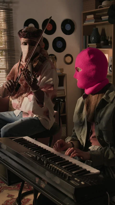 Vertical of Two Masked Musicians Performing Synth and Violin in Home Studio Stock Footage 335404595