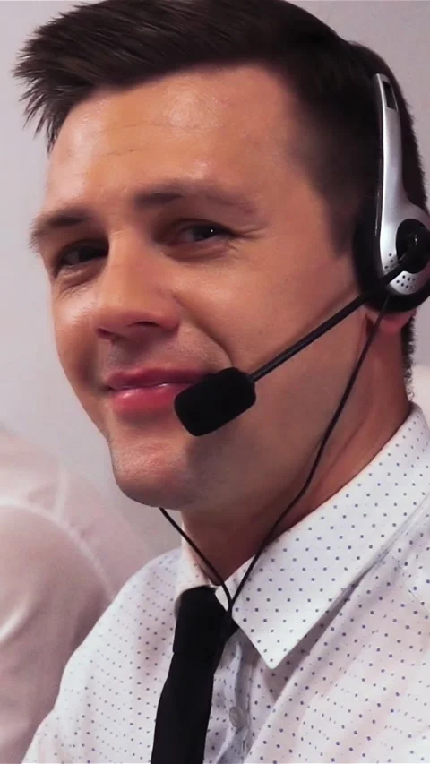 Vertical of Two men with headsets talking on voice call centre Stock Footage 305506200