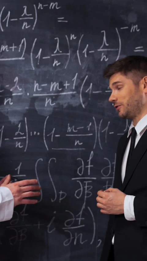 Vertical of Two scientists writing, discussing and analyzing math equations on a Stock Footage 305518061