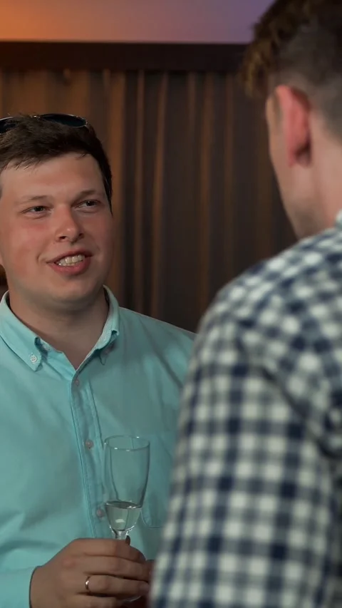 Vertical of Two smiling guys speaking at party Stock Footage 278476738