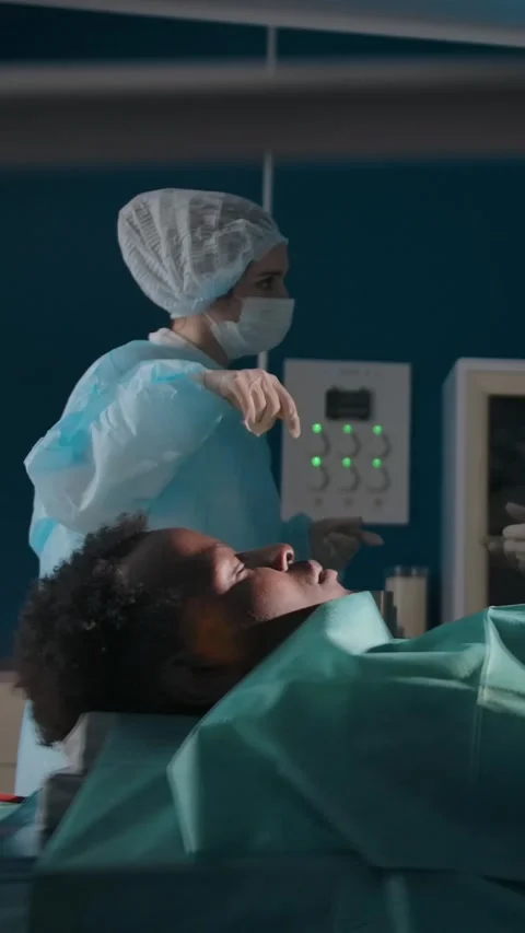 Vertical of Two surgeons discuss patient treatment in operating room Stock Footage 276929005