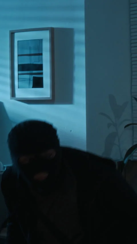 Vertical of Two Young Burglars Carefully Jumping off Windowsill Committing Crime Video stock 321696813