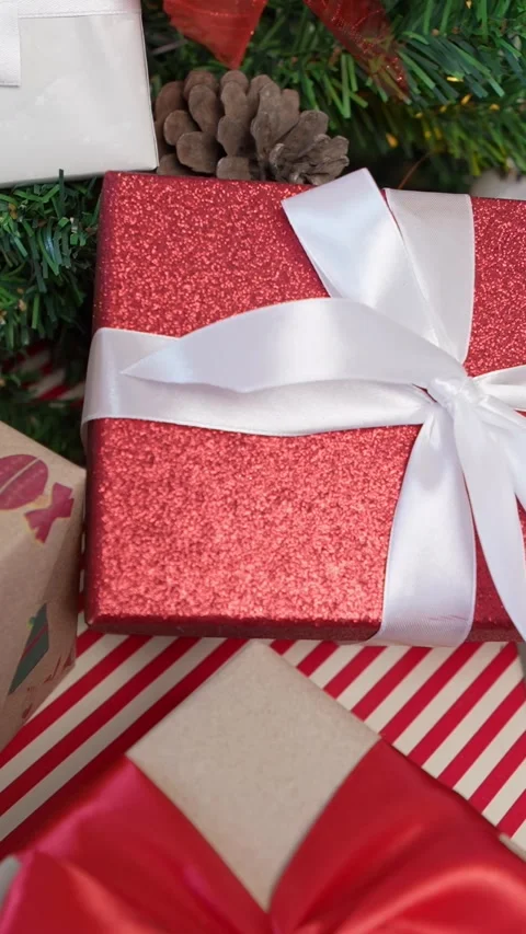 Vertical Under a Christmas tree, wrapped gift boxes enhance the holiday ambiance Stock Footage 315237299