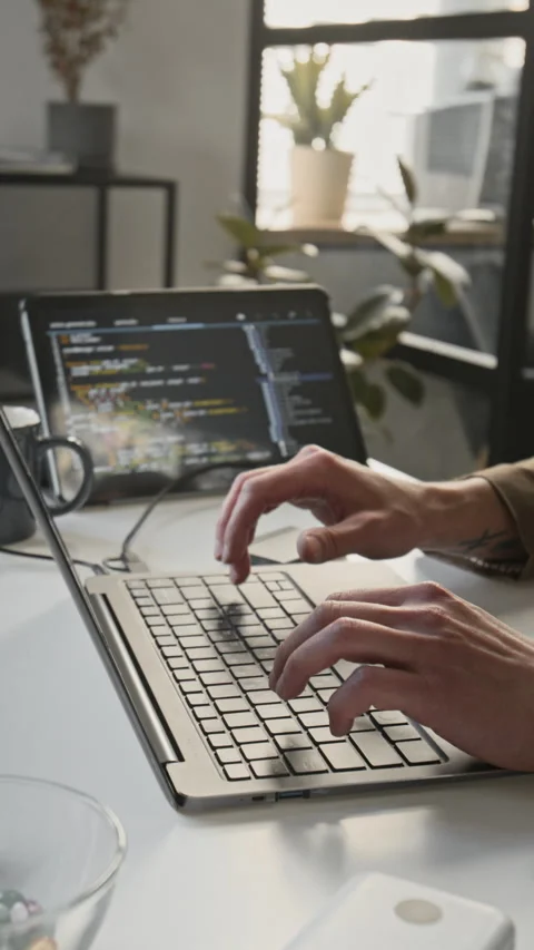 Vertical of Unknown Male Programmer Typing Code on Laptop Keyboard in Office Stock-Footage 336717249