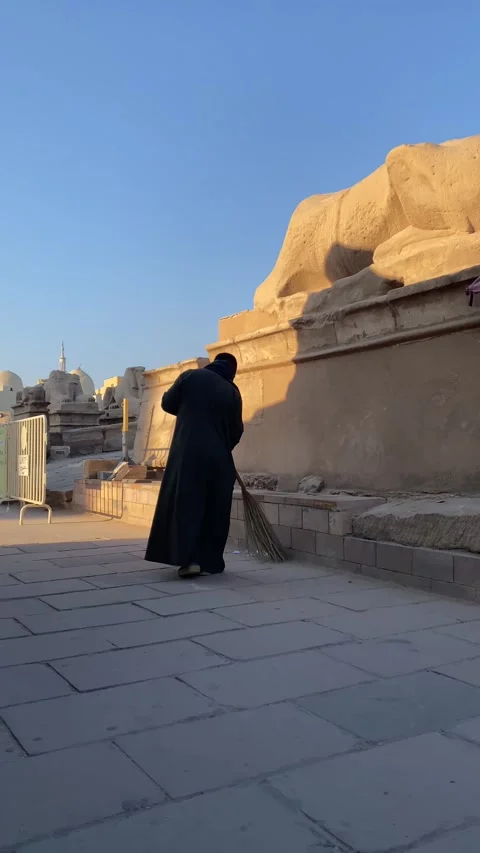 Vertical of unrecognizable arab man from the back sweeping the street floor Stock Footage 232608779