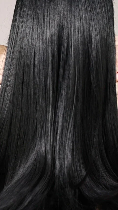 Vertical unrecognizable female model with long black straight hair, slow motion Stock Footage 288493056