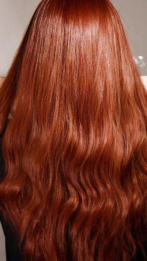 Vertical unrecognizable female model with long red curly hair in slow motion Stock Footage 307820523