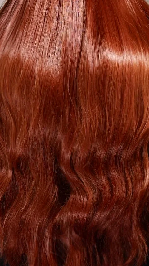 Vertical unrecognizable female model with long red curly hair in slow motion Stock Footage 308350598