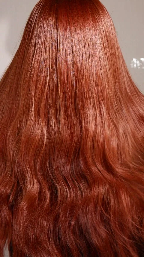 Vertical unrecognizable female model with long red curly hair in slow motion Stock Footage 308906128