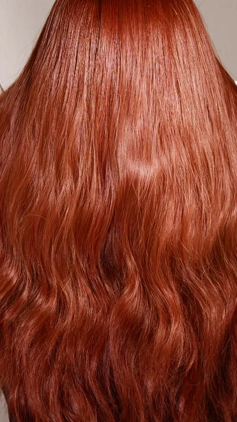 Vertical unrecognizable female model with long red curly hair in slow motion Stock Footage 309503409