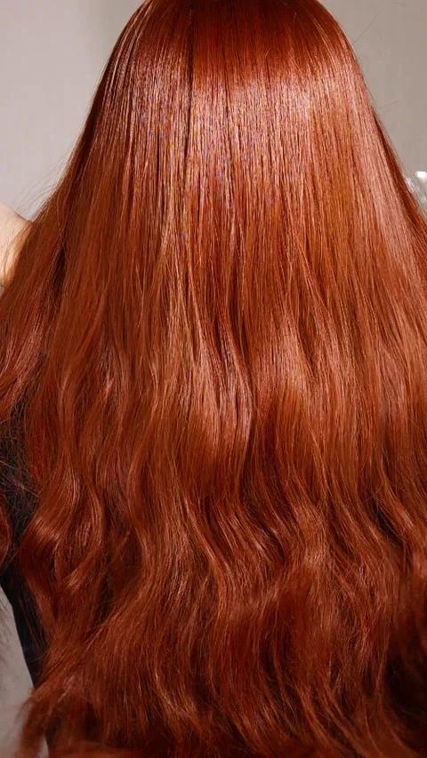 Vertical unrecognizable female model with long red curly hair in slow motion Stock Footage 310928087