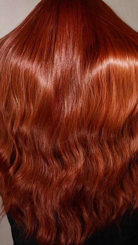 Vertical unrecognizable female model with long red curly hair in slow motion Stock Footage 311511488