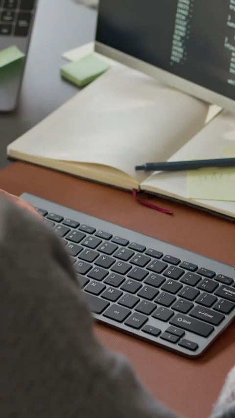 Vertical of Unrecognizable Male Programmer Working at Office Desk Stock Footage 306830946