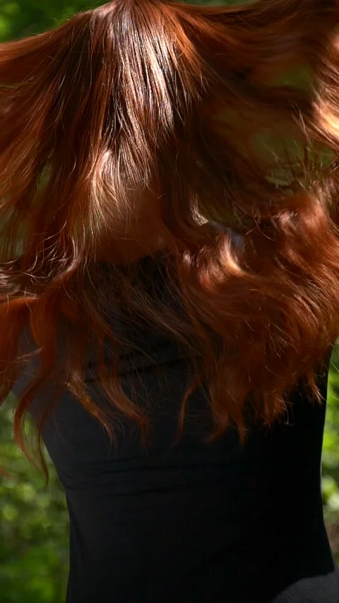 Vertical unrecognizable model with long healthy red curly hair in slow motion Stock Footage 284067946