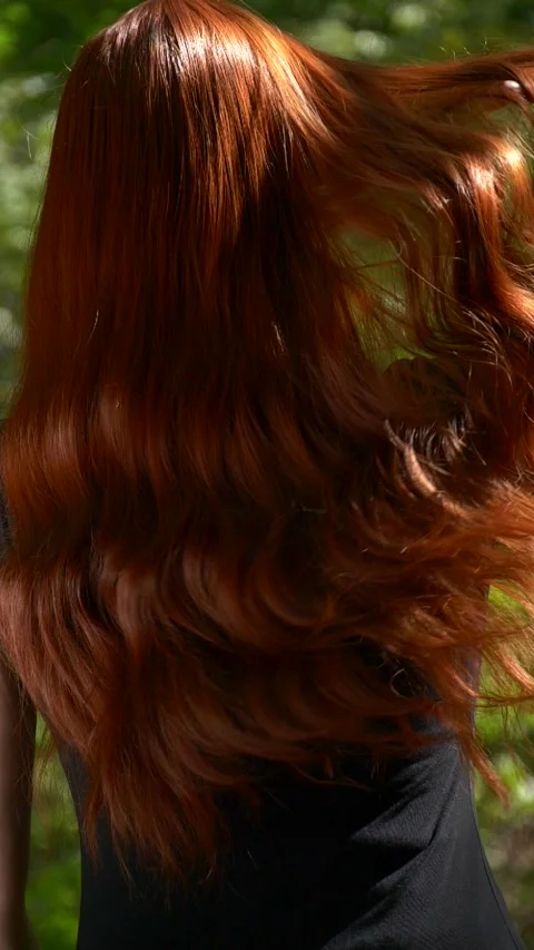Vertical unrecognizable model with long healthy red curly hair in slow motion Stock Footage 285481838