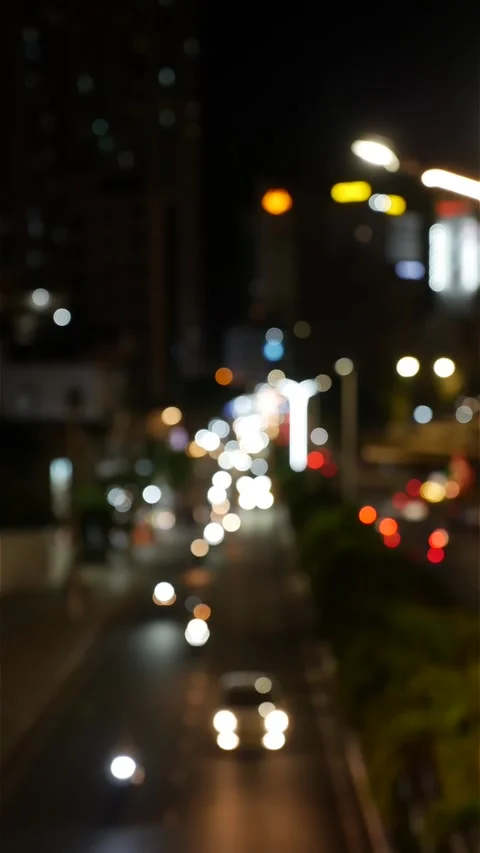 Vertical urban night frame with out of focus car lights and street lamps forming 動画素材 333632731