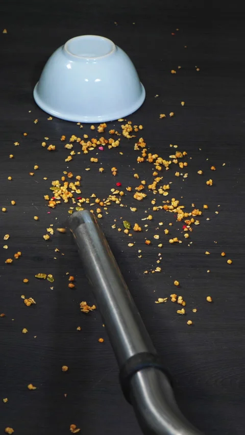 Vertical - Vacuum cleaner sucking up spilt cereal from the floor. Stock Footage 281168526