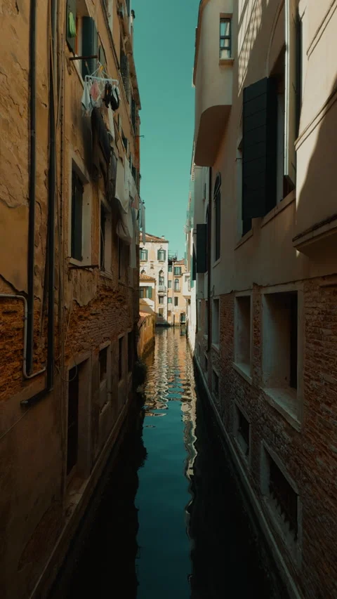 Vertical Venice canal scene between aged ochre buildings Stock Footage 336711982