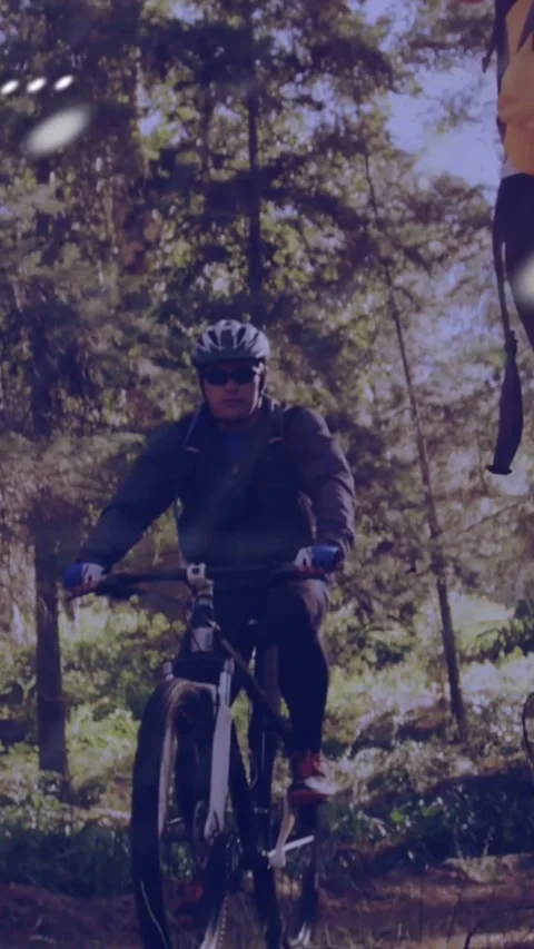 Vertical video: 2 riders riding trail, camera panning layering dotted map and Stock Footage 334382466