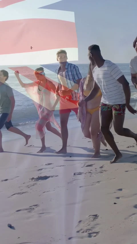 Vertical video: 7 friends running along beach after calling, UK flag drifting Video stock 333513668