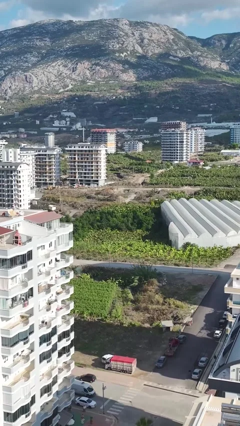Vertical Video: Active construction zone with workers pouring concrete for a Stock Footage 297652940