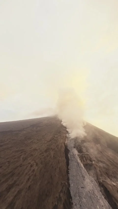 Vertical video. Active volcano peak eruption summit smoke cloud stream natural Stock Footage 254603013
