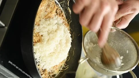 Vertical video. Adding rice to the vermicelli. Stage of preparing pilaf. Video stock 311046176