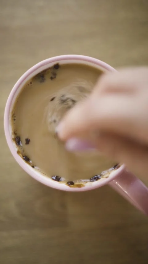 Vertical video of adding sugar and stirring cold iced coffee reel closeup Vídeos de archivo 342240581